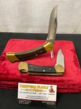 Pair of Buck Folding Hunting Knives, Wood, Brass, and Stainless Steel, #s 110 & 112