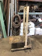 Rolling metal cart with hoisting platform. Works well.