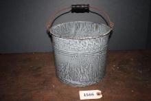Grey enamel bucket with wooden handle