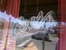 Coors Original Neon Sign in Window Near Corner