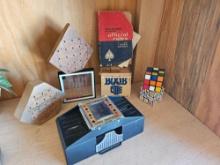 Funny game grouping, including Rubik's cubes, card shuffler, IQ tester, boob cube puzzle.
