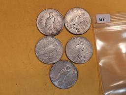 Five mixed Peace Silver Dollars