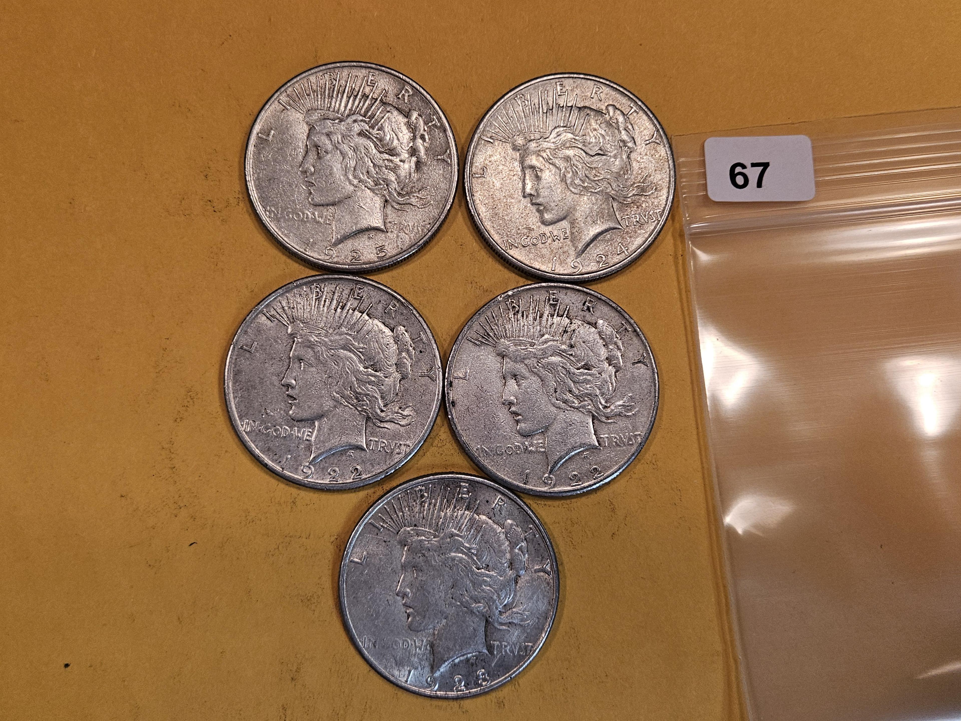 Five mixed Peace Silver Dollars