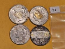 Four mixed Morgan and Peace Silver Dollars