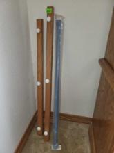 2 wall mounted coat hangers and shower rod