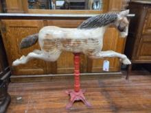 Carousel style hand carved wooden horse on metal stand