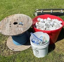 Spool of 12/2 Electric Wire and Tub of PVC Fittings and Sprinkler Repair Components