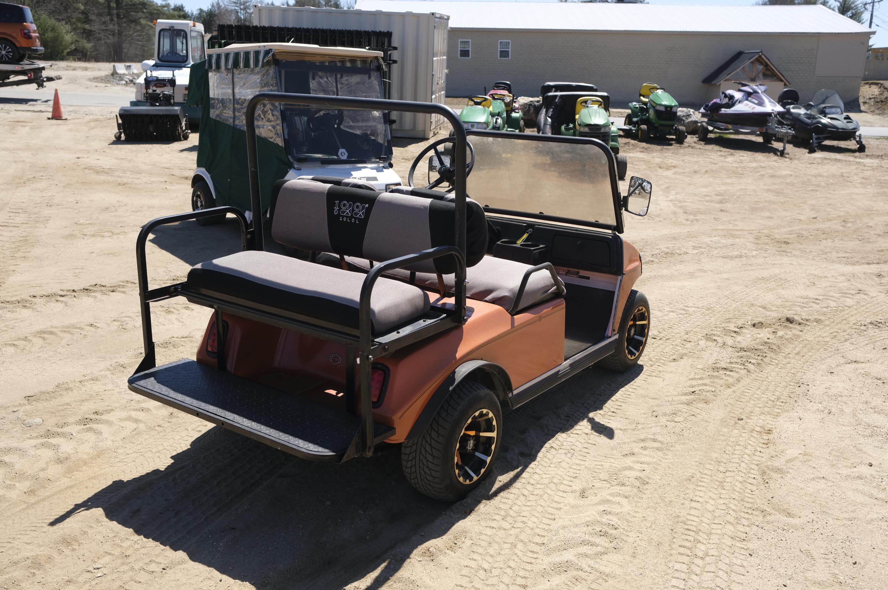 Orange Club Car 4 passenger golf cart