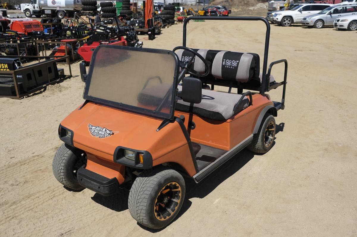 Orange Club Car 4 passenger golf cart