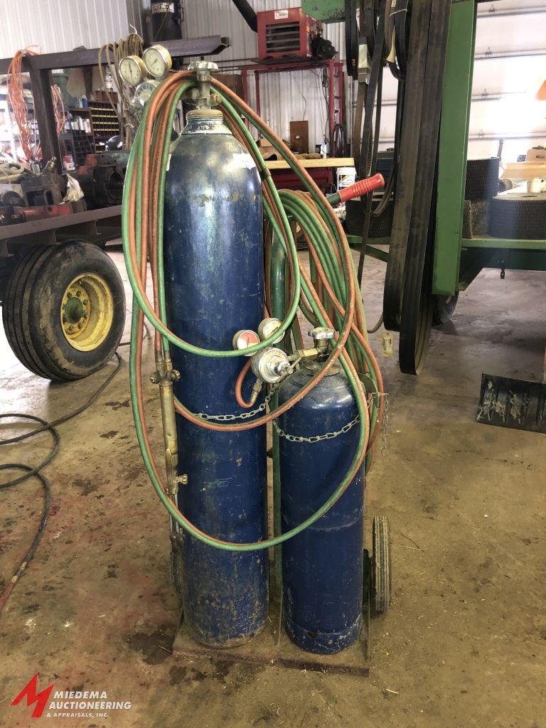OXYGEN/ACETYLENE TANK CART WITH APPROX. 30' OF HOSE, GOGGLES, TORCH, AND REGULATORS (TANKS ARE BELIE