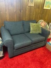 Blue love seat in basement