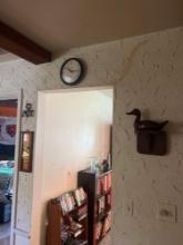 wooden duck clock and more on wall in living room