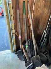 group of yard tools - shovels, rake, axe