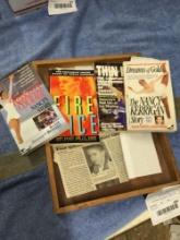 wooden tray of Nancy Kerrigan books with newspaper article