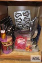 Cupboard lot of baking dishes and cookie cutters