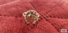 Gold colored horse with horseshoe around it ring, horseshoe has clear gemstone chips, marked 10K