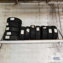 Lot of assorted tires on wooden rack