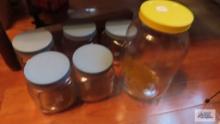 Assorted glass containers with screw on lids