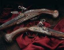 Pair of Ornate Silver Mounted Madrid-Lock Pistols