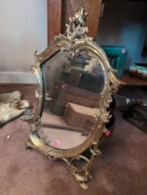(LR) VINTAGE ORNATE BRASS WALL HANGING MIRROR WITH CANDLE HOLDER. MEASURES 12-1/2"W X 21"T.