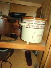 (KIT) CABINET LOT OF ASSORTED ITEMS TO INCLUDE, RIVAL CROCK POT SLOW COOKER, THE CASES COVE