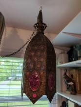(BR2) ANTIQUE ARABIC PIERCED METAL HANGING LIGHT WITH RED CRACKLE GLASS ACCENTS. IT MEASURES 30"T.