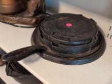 (BR2) 2 PC. CAST IRON LOT TO INCLUDE A W.J. LOTH STOVE CO. #9 SKILLET & A J.A. SHEPPARD & CO. WAFFLE