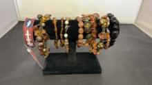 11) AMBER/BROWN TONE BEADED FASHION BRACELETS.