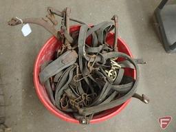 Large plastic bucket of leather horse harness
