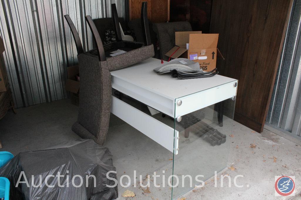 10x10 unit containing a modern desk, 4 upholstered dinning chairs, wood corner bookshelf, empty
