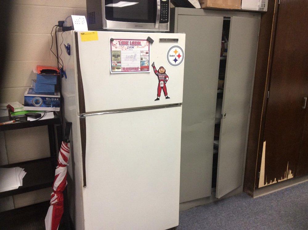 General Electric refrigerator and metal cabinet. Contents not included