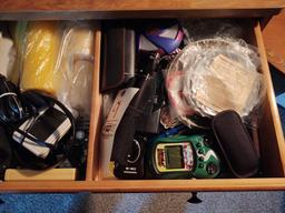 Drawer of Assorted Items Incl. Glassware, CD Player, Maglite, recorders, hand-held video games