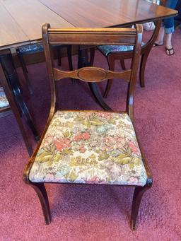 Mahogany Duncan Phyfe style dining table with 8 chairs, 7' long w/ leaves, 38" wide.