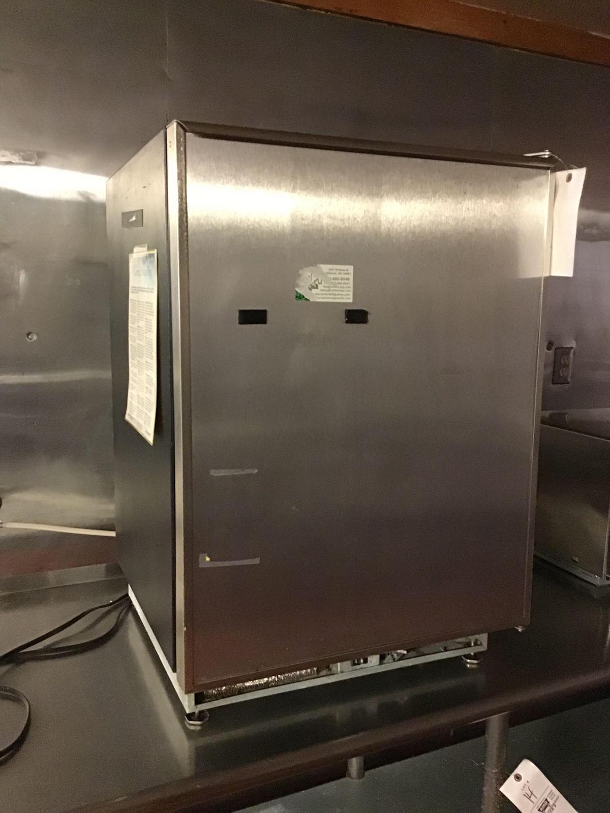 Small stainless steel front freezer with ice maker.