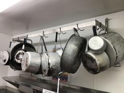 Pot rack with assorted pots and pans. With 10' stainless shelf