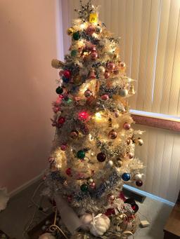 White Christmas tree full of vintage ornaments