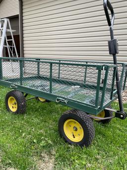 Like new 4 wheel utility yard cart with drop down side