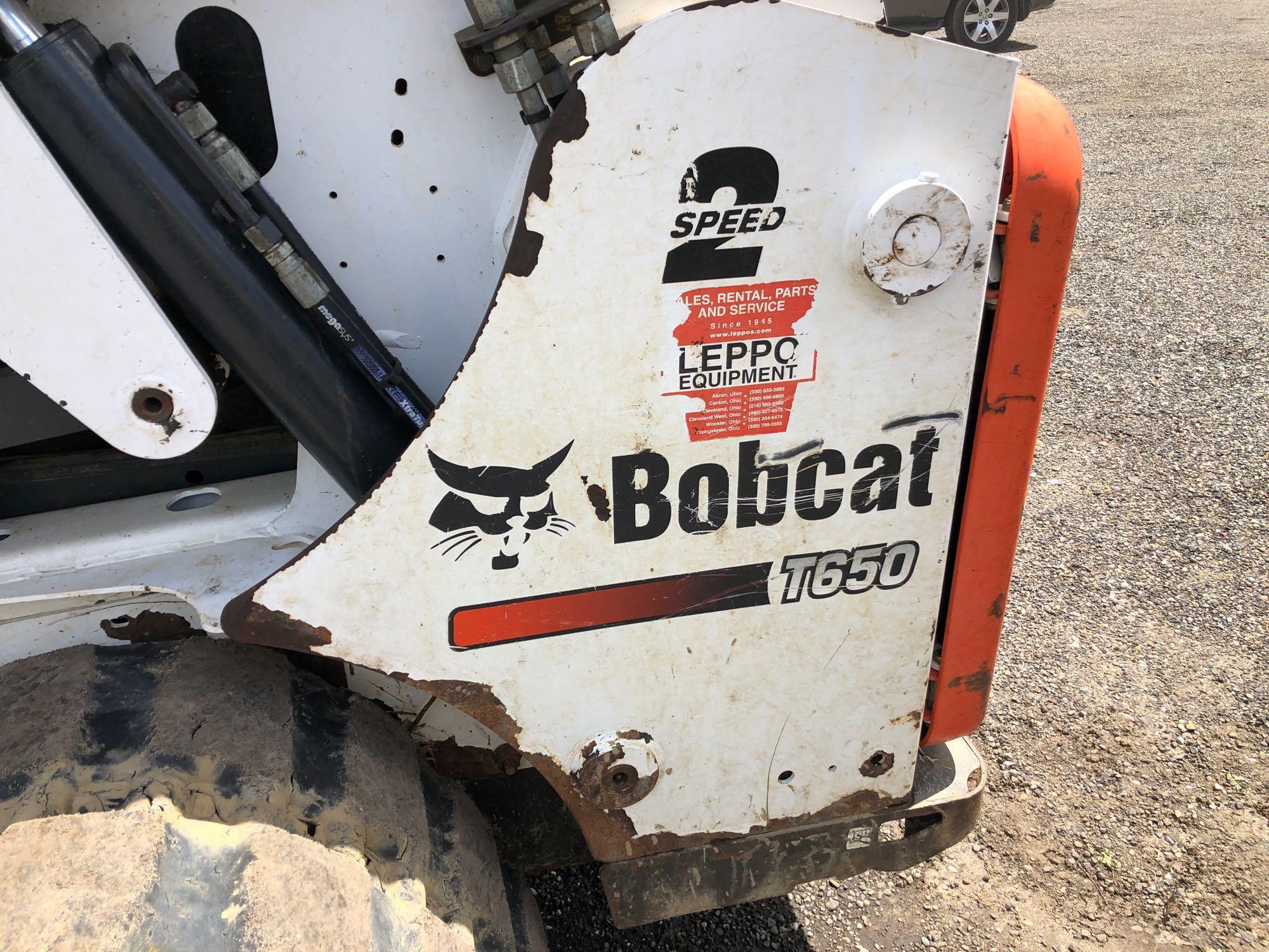 2013 Bobcat T650 with 2 speed, remotes, Bobcat tach quick release, heat & A/C, material bucket