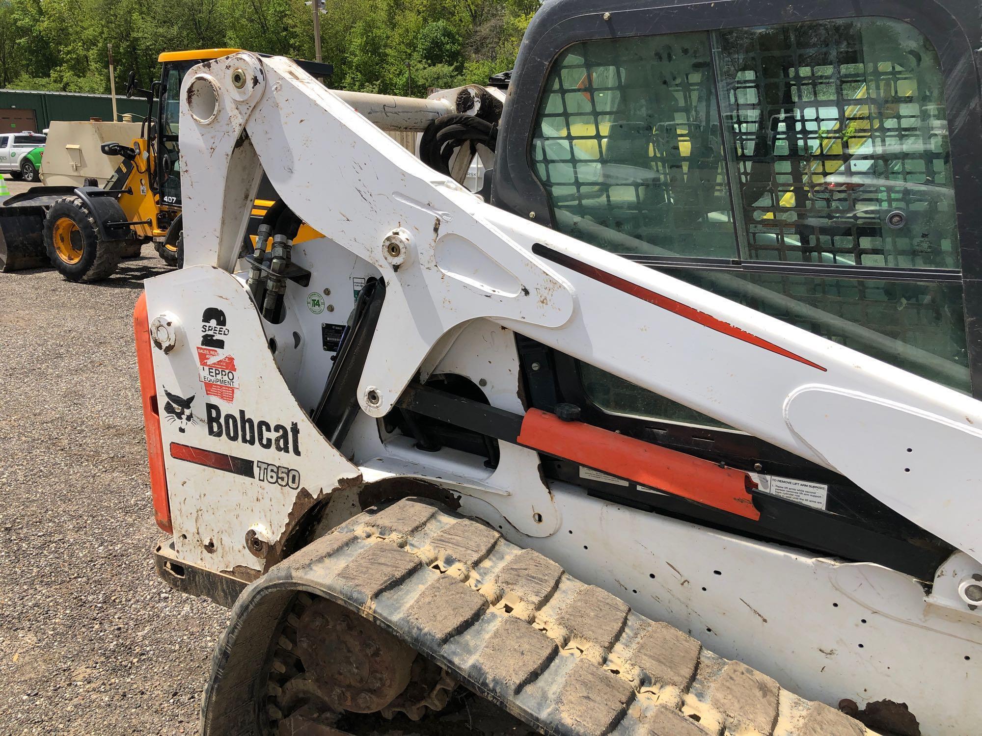 2013 Bobcat T650 with 2 speed, remotes, Bobcat tach quick release, heat & A/C, material bucket