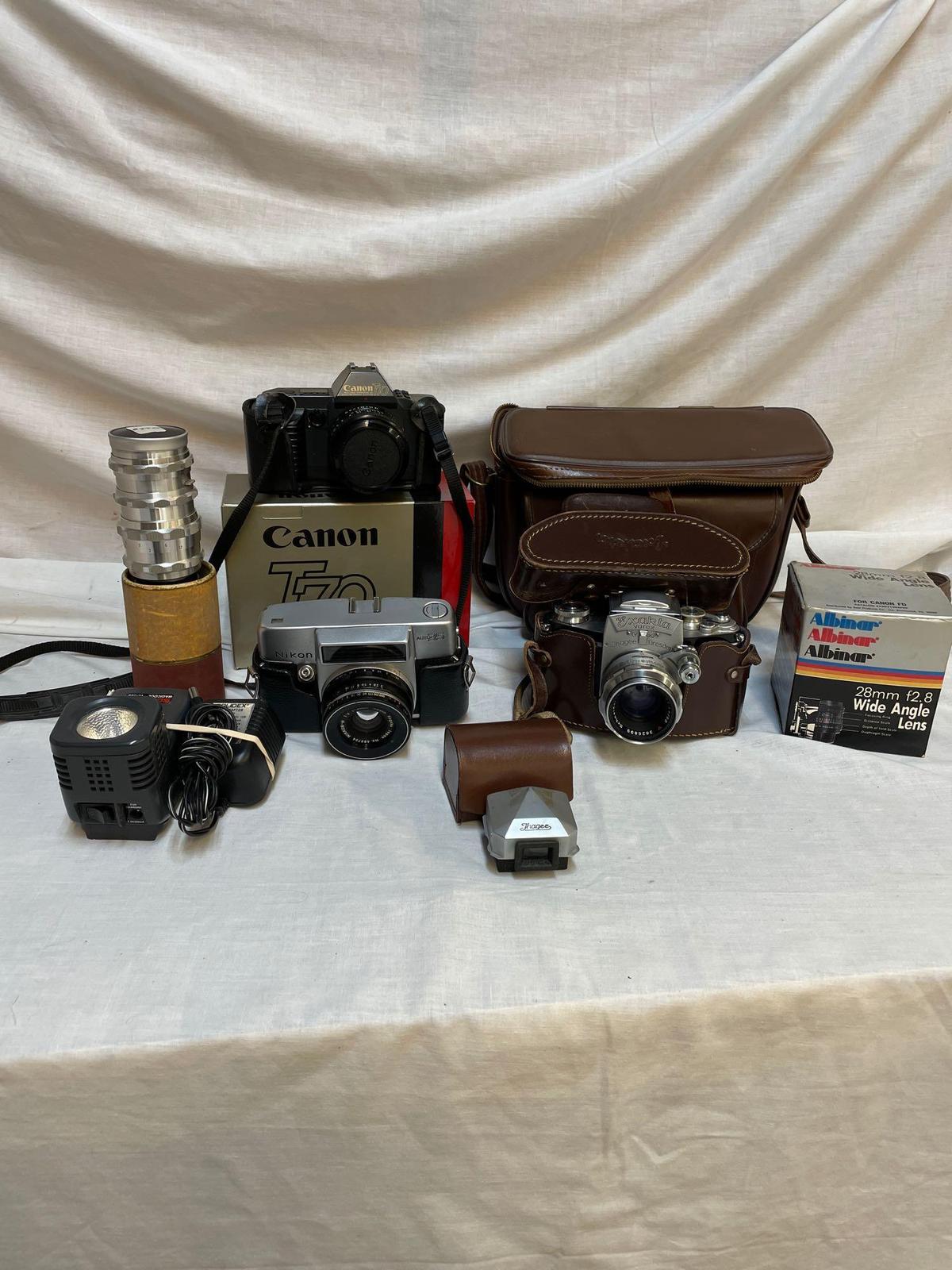 Collection of vintage cameras, Canon T70, Exakta Varex, Nikon auto 35, misc accessories