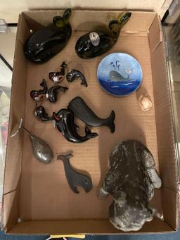 Metal dog figurine and a collection of whale figurines