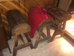 three saddle stands and horse blanket