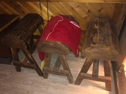 three saddle stands and horse blanket