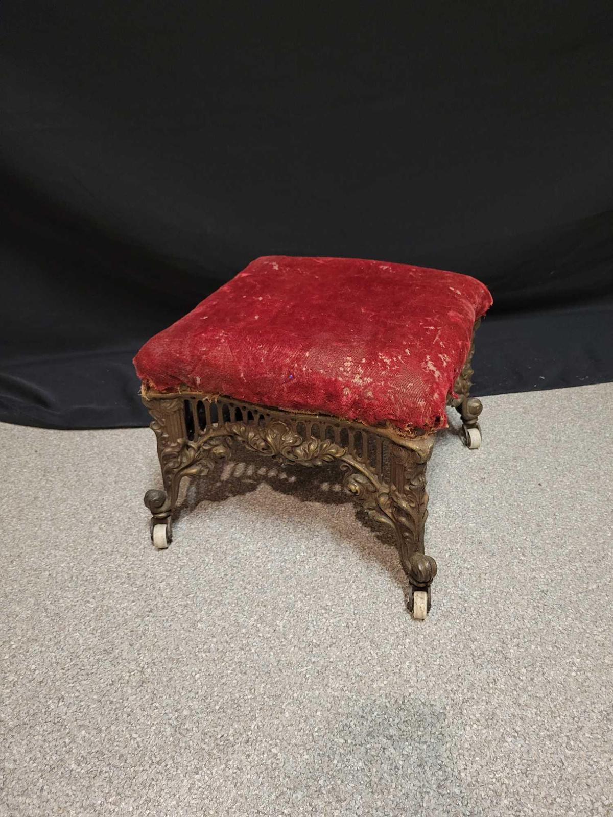 Antique foot stool with cast iron base and casters