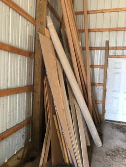 large lot of lumber and drain pipe.