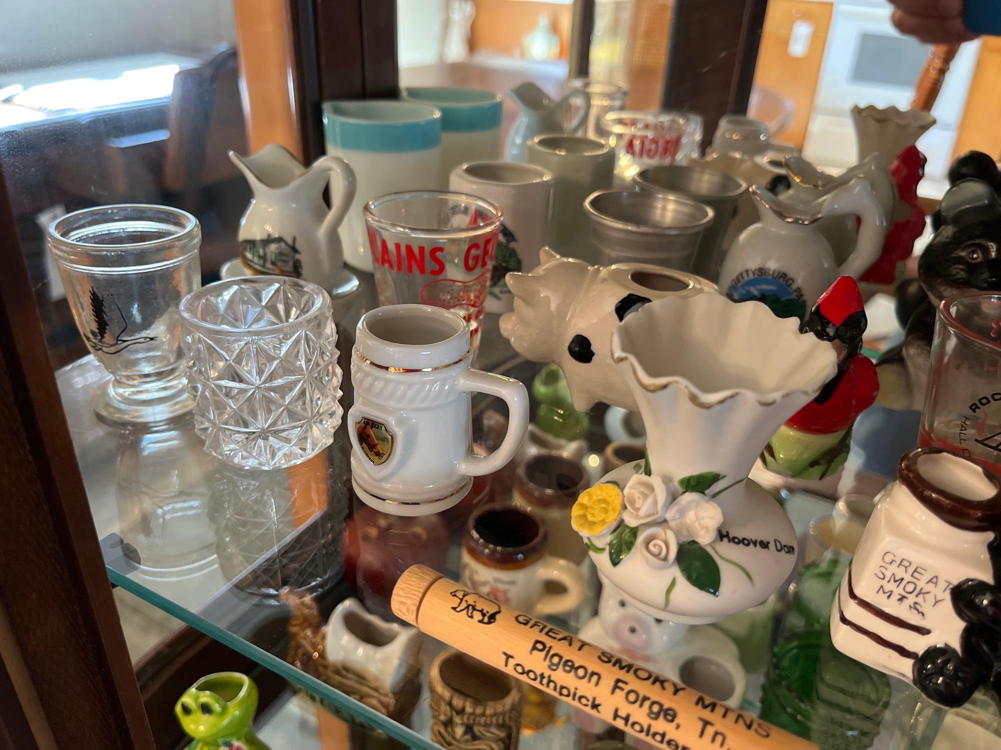 3 shelves of toothpick holders, shot glasses, souvenir items