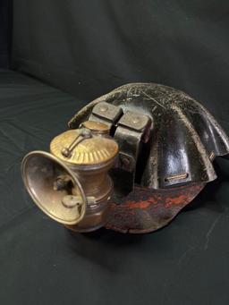 Vintage leather wrapped miner helmet with carbide light