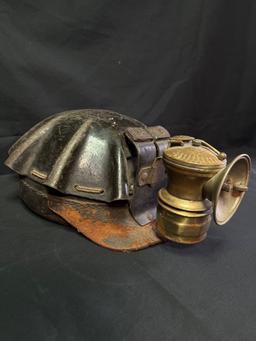 Vintage leather wrapped miner helmet with carbide light