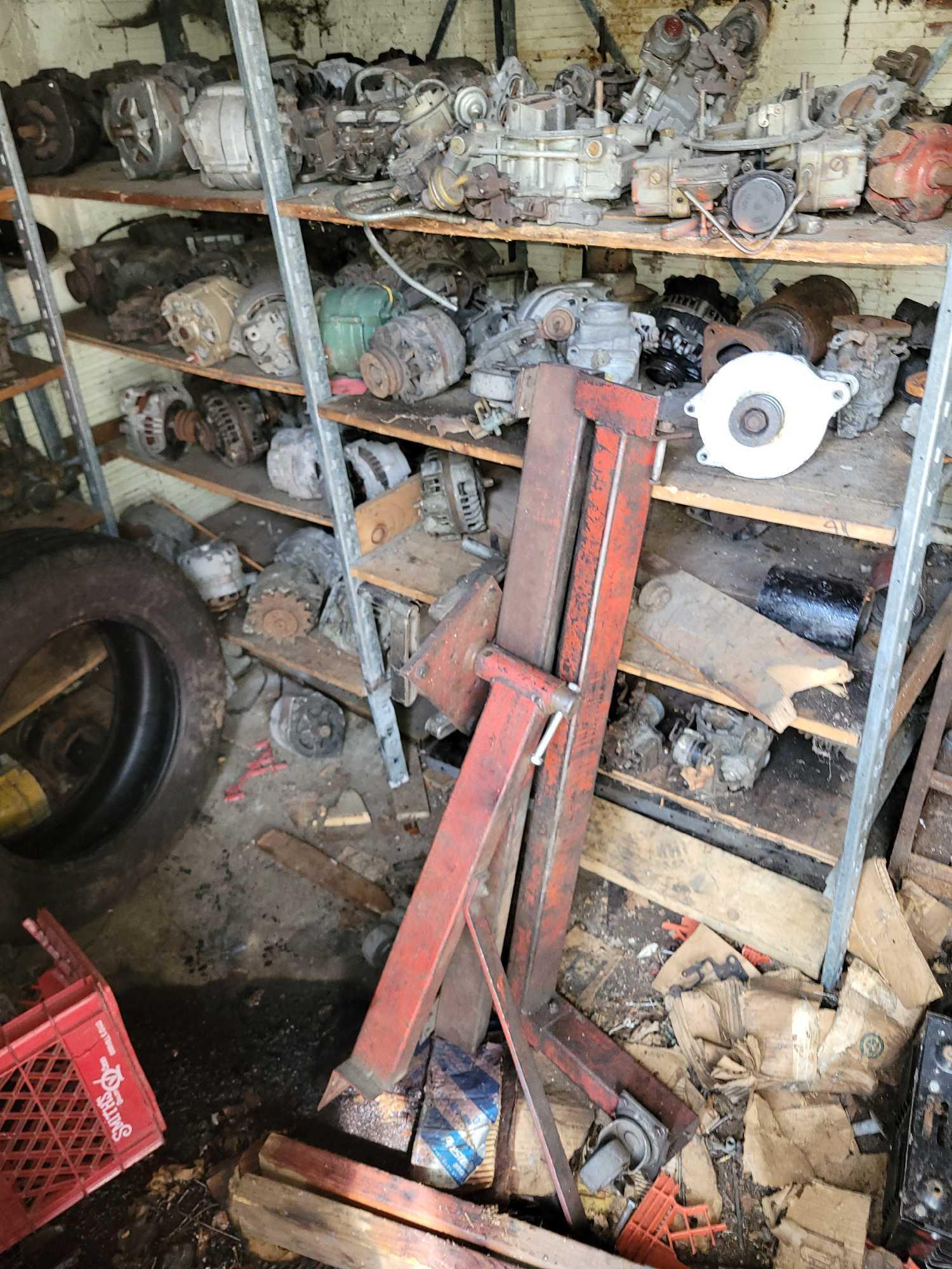 Contents of building, carburetors, engine stand, motor, scaffolding pieces, and more