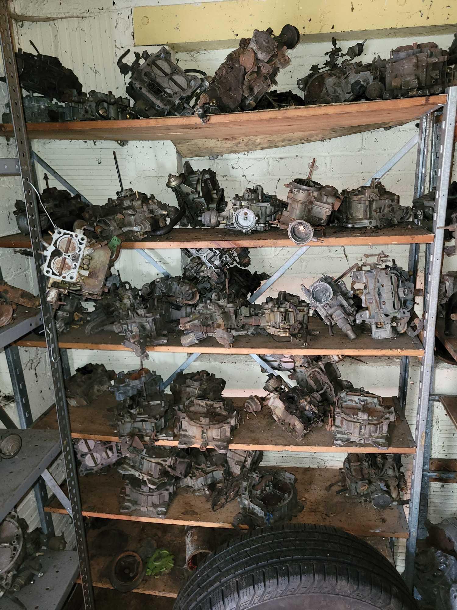 Contents of building, carburetors, engine stand, motor, scaffolding pieces, and more